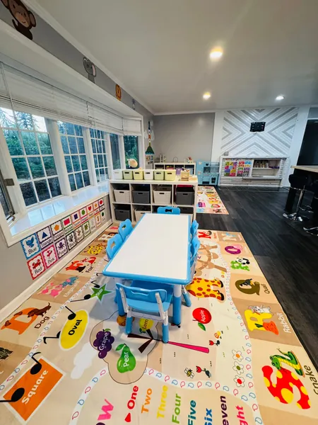 Educational learning space with blue table, chairs, and learning materials