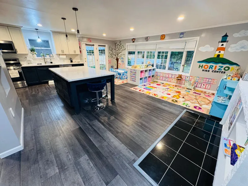 Full view of open-concept facility with kitchen island and learning areas