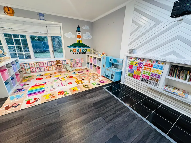 Wide view of learning space with lighthouse branding and educational displays